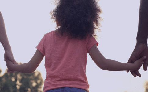 Child holding parents hands