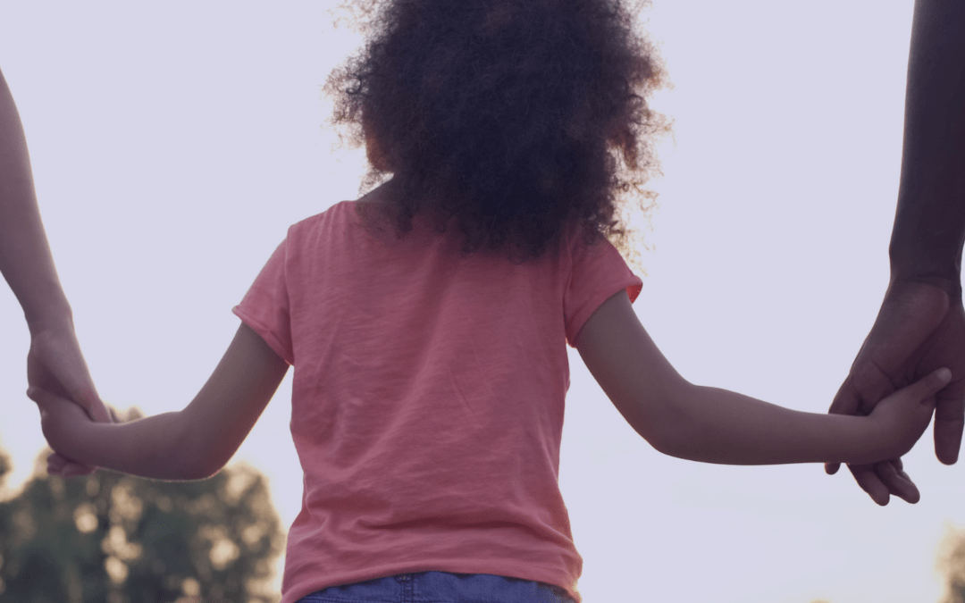 Child holding parents hands
