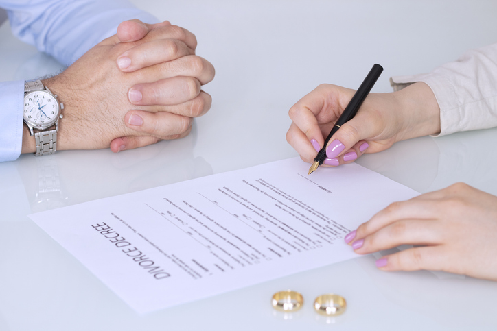 couple signing divorce papers