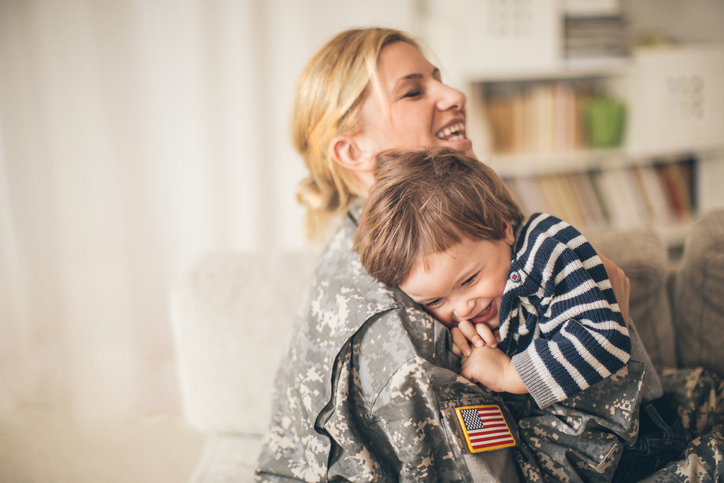 service member hugging her son