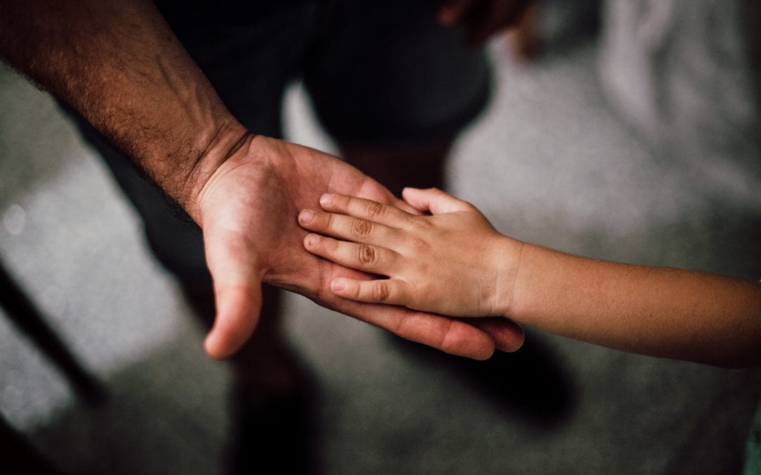 child holding parents hand
